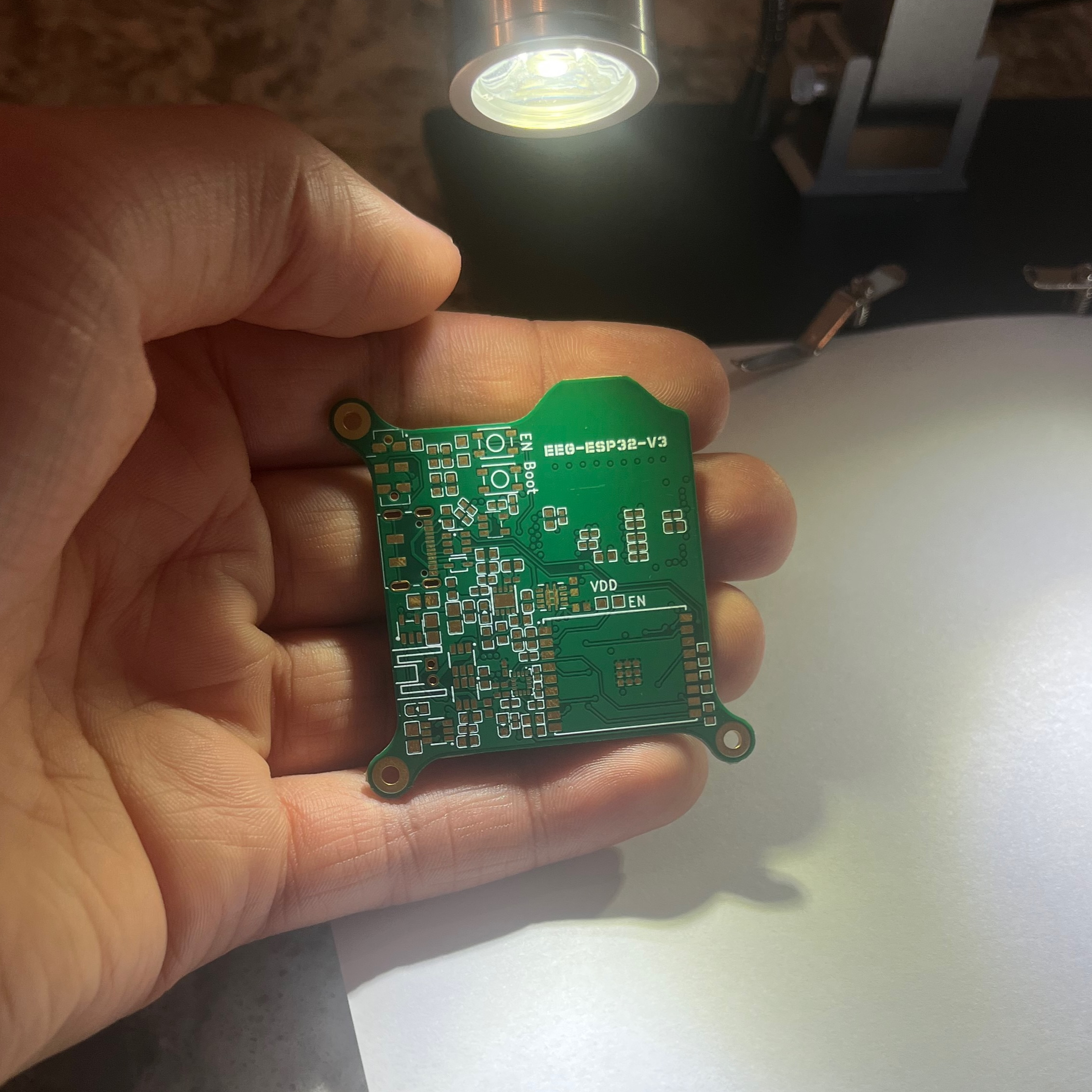 Bare unpopulated PCB held in hand